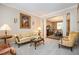 Cozy living room features floral patterned sofa, elegant decor, and seamless flow into the dining area at 4608 Regency Dr, Durham, NC 27713