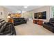 Spacious living room featuring an open floorplan, plush seating, and view to kitchen at 4608 Regency Dr, Durham, NC 27713