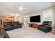 Large living room with a ceiling fan, television, fireplace, and French doors to the back at 4608 Regency Dr, Durham, NC 27713