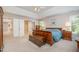 Spacious main bedroom with neutral walls, ceiling fan, with large bed, chest and matching dressers at 4608 Regency Dr, Durham, NC 27713