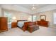 Spacious main bedroom with neutral walls, ceiling fan, with large bed, chest and matching dressers at 4608 Regency Dr, Durham, NC 27713