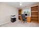 Functional office space with ample storage provided by wooden shelving, perfect for working from home at 4608 Regency Dr, Durham, NC 27713