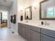 Bright bathroom featuring a double vanity, gray cabinets, quartz countertop and tiled floors at 49 Mount Joy Pl, Sanford, NC 27330