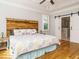 Primary bedroom with a unique wood headboard and ensuite bathroom featuring sliding barn doors at 49 Mount Joy Pl, Sanford, NC 27330