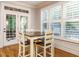 Bright dining area featuring a wood table set, hardwood floors, and natural light from the windows and door at 49 Mount Joy Pl, Sanford, NC 27330