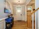 Open foyer with hardwood floors, staircase, decorative console table, and natural light at 49 Mount Joy Pl, Sanford, NC 27330