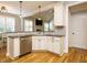 Open-concept kitchen area with granite countertops, stainless steel dishwasher, and hardwood floors at 49 Mount Joy Pl, Sanford, NC 27330