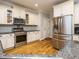 Bright kitchen with stainless steel appliances, white cabinetry, and tile backsplash at 49 Mount Joy Pl, Sanford, NC 27330