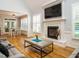 Cozy living room featuring a fireplace, large TV, and views of the breakfast nook at 49 Mount Joy Pl, Sanford, NC 27330