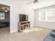 Inviting living room with a fireplace, TV stand and plush gray couch with great natural light at 49 Mount Joy Pl, Sanford, NC 27330