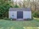 Well-maintained outbuilding or shed features a double door entry and is landscaped with shrubs and flowers at 49 Mount Joy Pl, Sanford, NC 27330