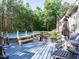 A pool deck provides a space for relaxation and enjoyment with comfortable seating and an umbrella for shade at 49 Mount Joy Pl, Sanford, NC 27330