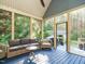Inviting screened porch features comfortable seating and a seamless connection to the serene outdoor setting at 49 Mount Joy Pl, Sanford, NC 27330