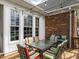 Inviting back deck area featuring a dining set and string lights, perfect for outdoor entertaining at 506 Wildwood Ln, Graham, NC 27253