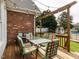 Inviting back deck area featuring a dining set and string lights, perfect for outdoor entertaining at 506 Wildwood Ln, Graham, NC 27253