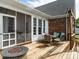 Back deck with a fire pit and built in grill, perfect for outdoor relaxation and entertainment at 506 Wildwood Ln, Graham, NC 27253