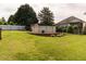 Large backyard with an above-ground pool and lush lawn, ideal for relaxation and outdoor entertainment at 506 Wildwood Ln, Graham, NC 27253