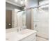 Modern bathroom featuring a sleek vanity, large mirror, glass shower, and neutral tones for a clean and stylish look at 506 Wildwood Ln, Graham, NC 27253