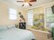 Bright bedroom with garden-themed wall art and a cozy bed at 506 Wildwood Ln, Graham, NC 27253