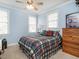 Inviting bedroom with a plaid comforter and plenty of natural light at 506 Wildwood Ln, Graham, NC 27253