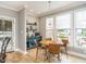 Cozy breakfast nook with natural light, a wood table, seating, and a view of the backyard pool at 506 Wildwood Ln, Graham, NC 27253