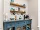 Charming coffee bar with a blue cabinet, decor shelves, and unique lighting at 506 Wildwood Ln, Graham, NC 27253
