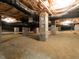 Exposed crawl space showing block piers, sandy ground, and plumbing, indicative of the home's foundation system at 506 Wildwood Ln, Graham, NC 27253