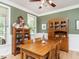 Inviting dining room with hardwood floors, a large table, and ample natural light at 506 Wildwood Ln, Graham, NC 27253