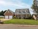 Traditional brick home with a manicured lawn, two-car garage, and inviting front porch at 506 Wildwood Ln, Graham, NC 27253