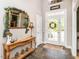 Warm foyer with a decorative table, mirror, and slate tile flooring at 506 Wildwood Ln, Graham, NC 27253