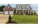 Charming brick home with a well-manicured lawn and attached two-car garage at 506 Wildwood Ln, Graham, NC 27253