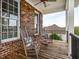 Cozy front porch seating area with rocking chairs and charming outdoor views at 506 Wildwood Ln, Graham, NC 27253