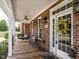 Inviting front porch with a seating area, ceiling fan, and views of the yard at 506 Wildwood Ln, Graham, NC 27253