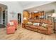 Cozy living room features a plush couch, an armchair, and hardwood floors with the kitchen in the background at 506 Wildwood Ln, Graham, NC 27253