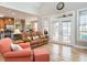 Spacious living room with hardwood floors, access to outdoor space, and comfortable seating at 506 Wildwood Ln, Graham, NC 27253