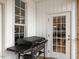 The porch features a Blackstone grill and a doorway into the home at 506 Wildwood Ln, Graham, NC 27253