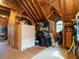 Spacious attic used for storage, featuring a white storage cabinet and organizing shelves at 506 Wildwood Ln, Graham, NC 27253