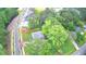 Aerial view shows the home nestled among mature trees with street and neighborhood access at 509 Olive Branch Rd, Durham, NC 27703