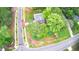 Overhead view of a light-blue two-story house nestled among verdant trees and manicured landscaping at 509 Olive Branch Rd, Durham, NC 27703