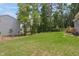 Expansive grassy backyard, bordered by mature trees, offers privacy at 509 Olive Branch Rd, Durham, NC 27703