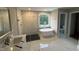 Luxurious bathroom with a freestanding tub, walk-in shower, marble countertops, and a serene view from the window at 509 Olive Branch Rd, Durham, NC 27703