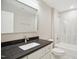 Bathroom featuring a vanity sink with dark stone countertop and tub-shower combo with tile surround at 509 Olive Branch Rd, Durham, NC 27703