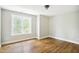 Bright bedroom featuring hardwood floors, neutral walls, and a large light-filled window at 509 Olive Branch Rd, Durham, NC 27703