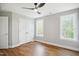 Bedroom with wood floors, a ceiling fan, and two large windows at 509 Olive Branch Rd, Durham, NC 27703