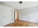 Neutral bedroom with hardwood flooring featuring a closet and open door with natural light at 509 Olive Branch Rd, Durham, NC 27703