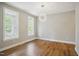 Bright, unfurnished bedroom with hardwood floors, neutral walls, modern lighting, and ample natural light at 509 Olive Branch Rd, Durham, NC 27703