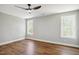 This bedroom has lots of natural light from the two windows and wood-look floors at 509 Olive Branch Rd, Durham, NC 27703