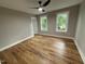 Spacious bedroom featuring new flooring, two windows, and neutral paint at 509 Olive Branch Rd, Durham, NC 27703