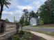 Street view of the Lochwood community sign, surrounded by trees and greenery, highlighting the neighborhood's entrance at 509 Olive Branch Rd, Durham, NC 27703