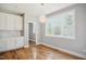 Bright dining area with wood floors and modern light fixture at 509 Olive Branch Rd, Durham, NC 27703